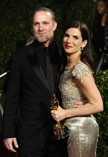 FILE - Sandra Bullock and Jesse James arrive at the Vanity Fair Oscar party on in this March 7, 2010 file photo taken in West Hollywood, Calif. Sandra Bullock has canceled her appearance at the London premiere of "The Blind Side" scheduled for Tuesday March 23, 2010 almost two weeks after winning a Best Actress Academy Award. In a statement released by Warner Bros UK., the 45-year-old actress says she can't attend the event for "unforeseen personal reasons." (AP Photo/Peter Kramer, File) (AP)