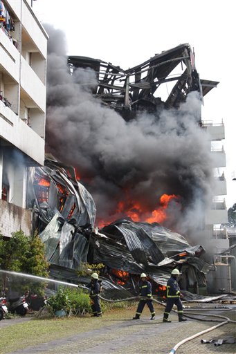 Firemen battle a blaze at a textile factory that started shortly after a strong earthquake jolted the island, Thursday, March 4, 2010, in the southern area of Tainan, Taiwan. A powerful 6.4-magnitude earthquake rocked southern Taiwan on Thursday morning, causing widespread damage, and disrupting communications around the island. (AP Photo) ** TAIWAN OUT ** (AP)