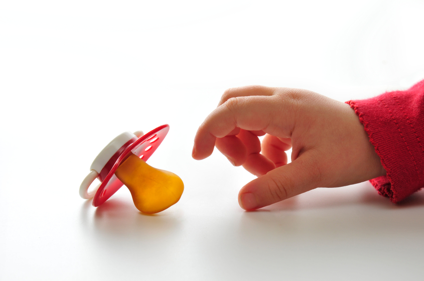 Children's dummy. Child taking the pacifier.