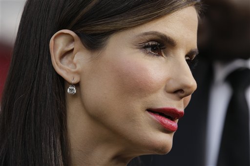 FILE - Sandra Bullock, arrives at the 82nd Academy Awards in this March 7, 2010 file photo taken in the Hollywood section of Los Angeles. In a story posted Wednesday April 28, 2010 on People magazine's website, Sandra Bullock says she has filed for divorce from her husband, Jesse James. The Oscar-winning actress also reveals that she is adopting 3 1/2-month-old boy, Louis Bardo Bullock as a single parent. (AP Photo/Amy Sancetta, File) (AP)
