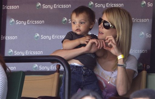 Elin Nordegren, the wife of Tiger Woods, sits with her son Charlie during a semifinal match between Rafael Nadal and Andy Roddick at the Sony Ericsson Open tennis tournament in Key Biscayne, Fla. Friday, April 2, 2010. (AP Photo/Lynne Sladky) (AP)