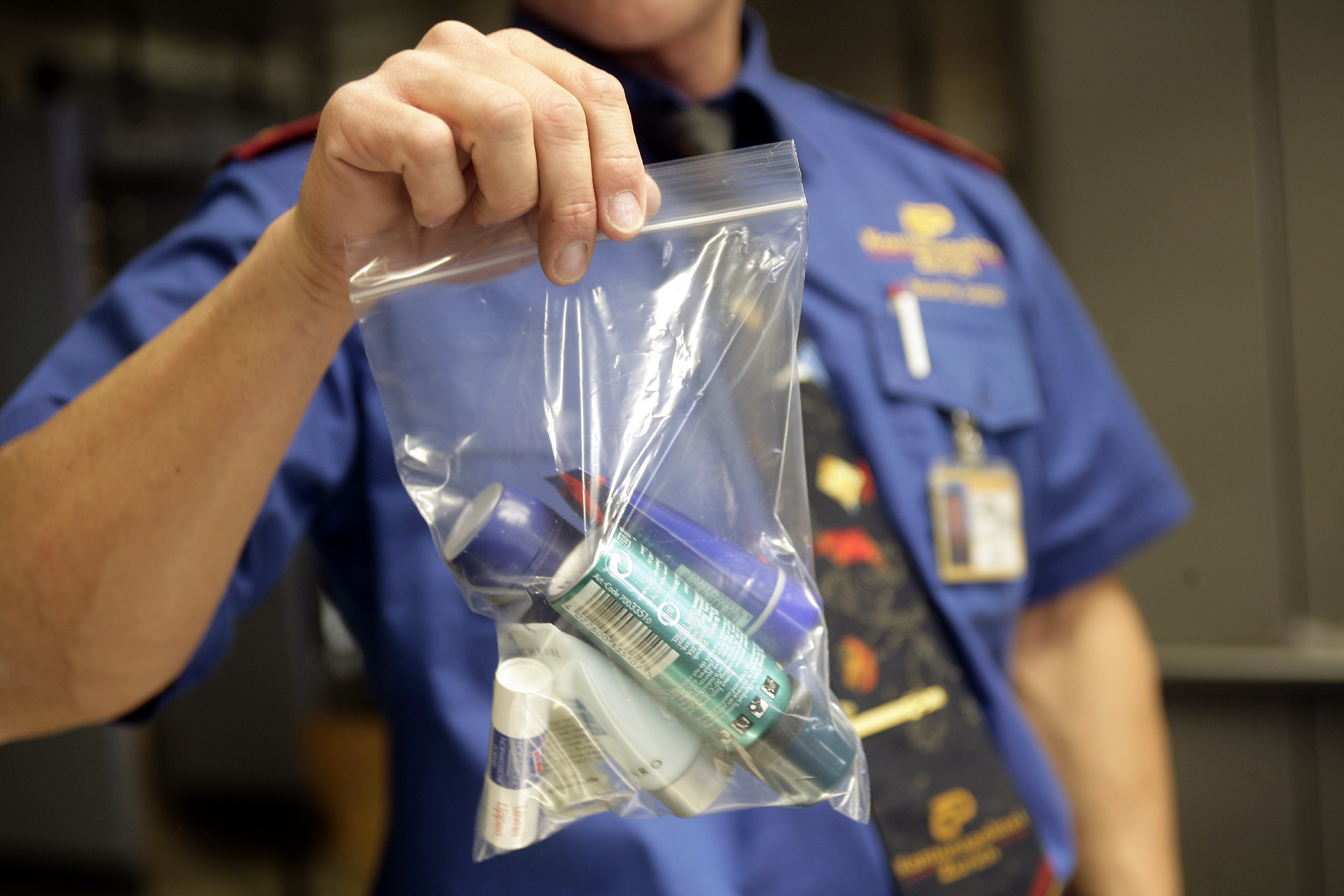 A security officer shows a plastic bag which contains a passenger's liquid belongings at a security gantry at Zurich airport November 6, 2006. Air travellers in Europe must pack water, perfumes, toothpastes and other liquids into a small plastic bag before going through airport security checkpoints under new rules that enter into force on Monday. The rules limit the amount of liquids people may take on board planes and reflect efforts to standardise measures put in place in Europe after London authorities said in August they had foiled a plot to bomb flights bound for the United States. REUTERS/Andreas Meier (SWITZERLAND) (Reuters)