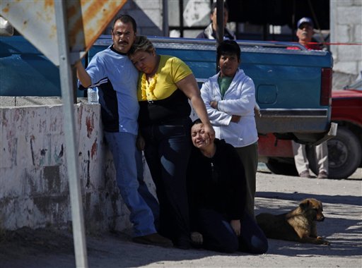 Family members of community leader Calisto Perez Mena react as they arrive near the place where he was killed in San Isidro, on the outskirts of Ciudad Juarez, Mexico. (AP Photo/Alexandre Meneghini)