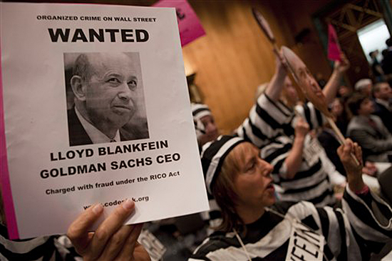Protestors hold up a photo of Goldman Sachs Chief Executive Officer Lloyd Blankfein on Capitol Hill in Washington, Tuesday, April 27, 2010, during the Senate Investigations subcommittee hearing. (AP Photo/Evan Vucci) (Evan Vucci)