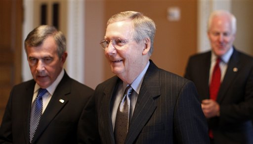 Senate minority leader Mitch McConnell, R-Ky., center, walks with Sen. Mike Johanns, R-Neb., left, and Sen. John Cornyn, R-Texas, towards the Senate floor for a crucial test vote for the financial reform bill on Capitol Hill in Washington, Monday, April 26, 2010. (AP Photo/Charles Dharapak) (AP)