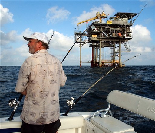 FILE - In a  in this Friday, May 9, 2003 file photo, angler Andy Hails, of Montgomery, Ala., checks the fishing lines on his boat as he trolls the Gulf of Mexico near a natural gas well off the Alabama coast near Gulf Shores, Ala. President Obama announced his new offshore drilling policy Wednesday, March 31, 2010. President Obama is allowing oil drilling off Virginia's shorelines and considering it for a large chunk of the Atlantic seaboard. At the same time, he's rejecting some new drilling sites that had been planned in Alaska.   (AP Photo/Dave Martin, File) (AP)