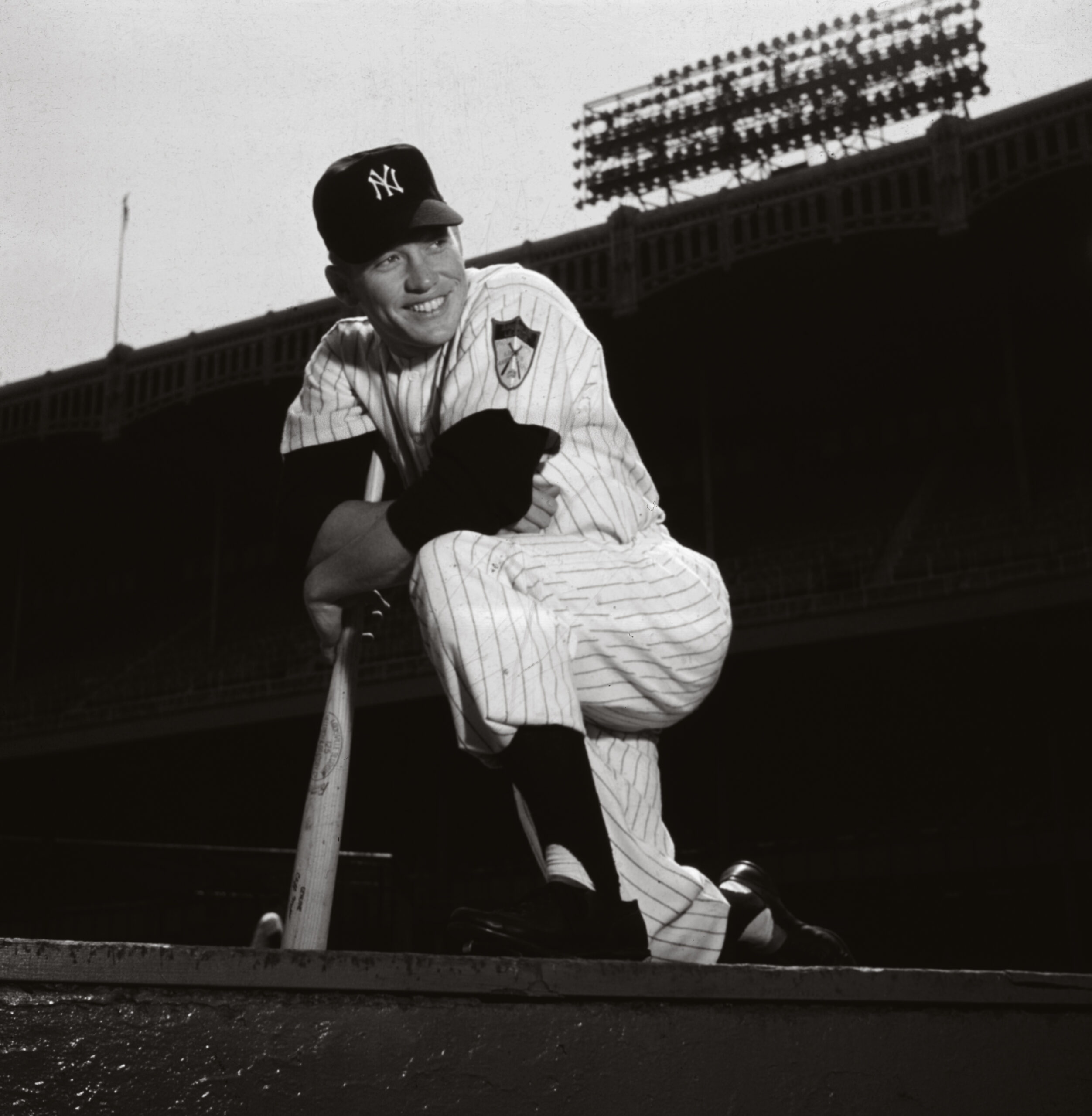 circa 1960:  Low-angle portrait of American baseball player and New York Yankees outfielder Mickey Mantle in uniform, smiling and kneeling on one leg on the ground of Yankee stadium, leaning on his bat, Bronx, New York City.  (Photo by Hulton Archive/Getty Images) (Hulton Archive)