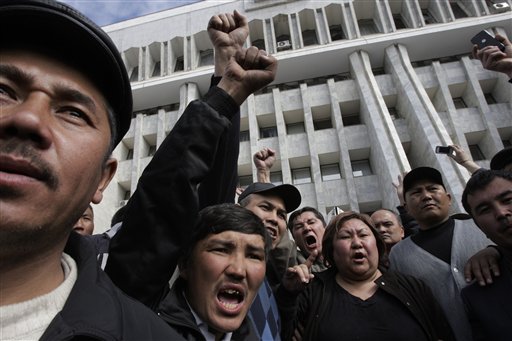 Protesters shout ant government slogans as they gather in front of Kyrgyz government headquarters on the central square in Bishkek, Kyrgyzstan, Thursday, April 8, 2010. An opposition coalition in Kyrgyzstan said it has formed an interim government that will rule the turbulent Central Asian nation for six months. Opposition leader Roza Otunbayeva said Thursday she will head the government that dissolved the parliament and will take up legislative duties.  (AP Photo/Alexander Zemlianichenko) (AP)