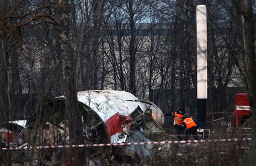 Rescue workers inspect the debris on the site of the plane crash near Smolensk, western Russia, Sunday, April 11, 2010. Polish President Lech Kaczynski, his wife and some of the country's most prominent military and civilian leaders died Saturday along with dozens of others when the presidential plane crashed as it came in for a landing in thick fog. (AP Photo/Sergey Ponomarev) (AP)