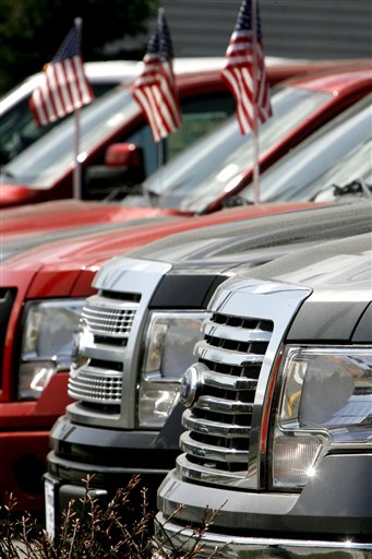 FILE - In this April 21, 2010 file photo, a line of 2010 Ford F-150 pickup trucks is seen at the Formula Ford dealership in Montpelier, Vt. Ford Motor Co. said Tuesday, April 27, it earned $2.1 billion in the first quarter, another sign the economy is improving as people spend more on big-ticket items like cars. (AP Photo/Toby Talbot, file) (AP)