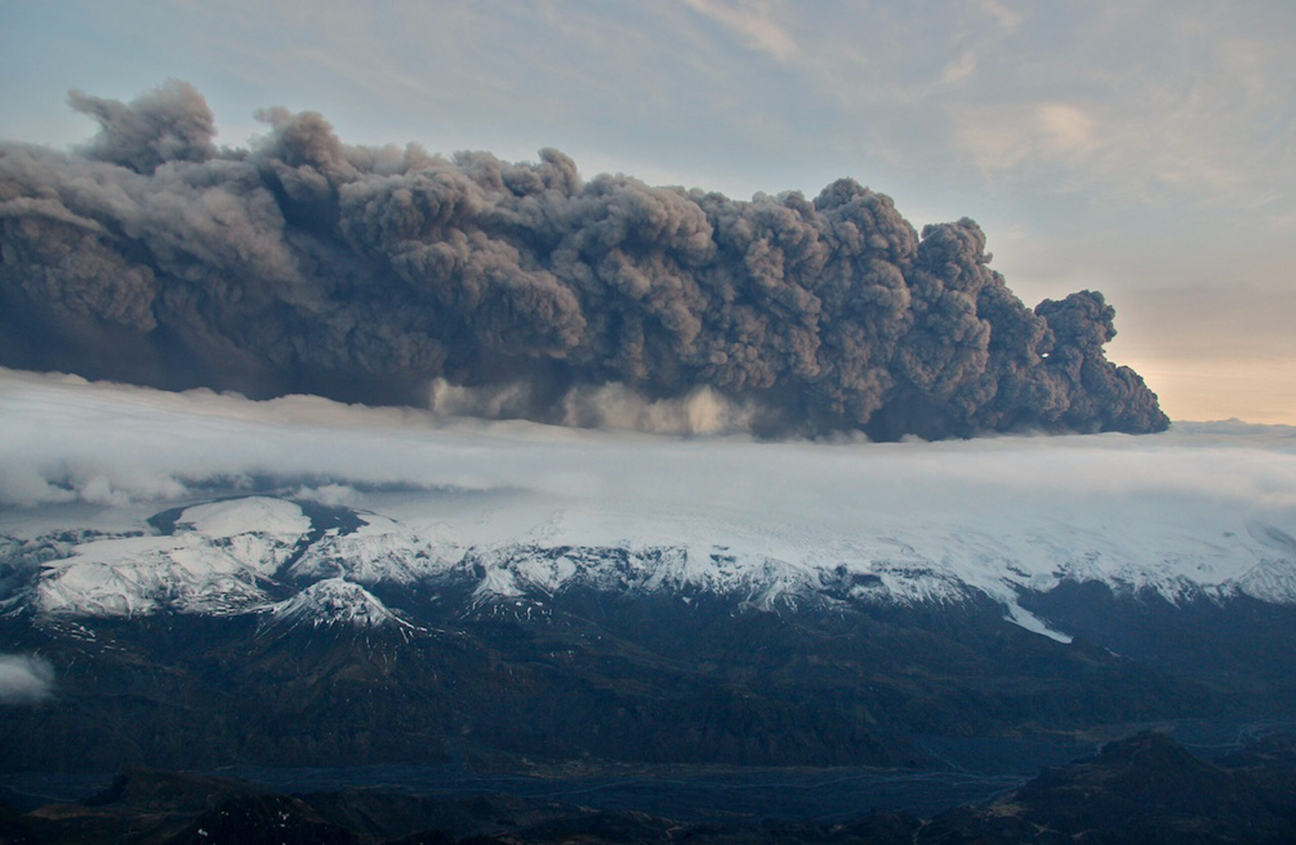 Smoke and steam hangs over the volcano under the Eyjafjallajokull glacier in Iceland, Wednesday April 14, 2010, which has erupted for the second time in less than a month, melting ice, shooting smoke and steam into the air and forcing hundreds of people to flee rising floodwaters. Volcanic ash drifting across the Atlantic forced the cancellation of flights in Britain and disrupted air traffic across northern Europe, stranding thousands of passengers. Flights in and out of London Heathrow, Europe's busiest airport, were halted, and the shutdowns and cancellations spread to France, Belgium, the Netherlands, Denmark, Ireland, Sweden, Finland and Switzerland. The volcano's smoke and ash poses a threat to aircraft because it can affect visibility, and microscopic debris can get sucked into airplane engines and can cause them to shut down.(AP Photo/Jon Gustafsson)  **  ICELAND OUT  ** (Associated Press)