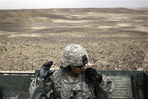 In this April 26, 2010, photo, U.S. Army Lt. David Cummings, of Raleigh, N.C., talks on the radio with soldiers from his platoon while out patrolling areas off of Highway 1 with A Troop, 2nd Battalion, 1st Infantry Regiment, 5th Stryker Brigade in the Kandahar province of Afghanistan. The American-led effort to wrest control of southern Afghanistan is off to a slow start and the political clock is ticking as U.S. troops head into what could be the bloodiest fight yet in the eight-year war. (AP Photo/Julie Jacobson) (AP)