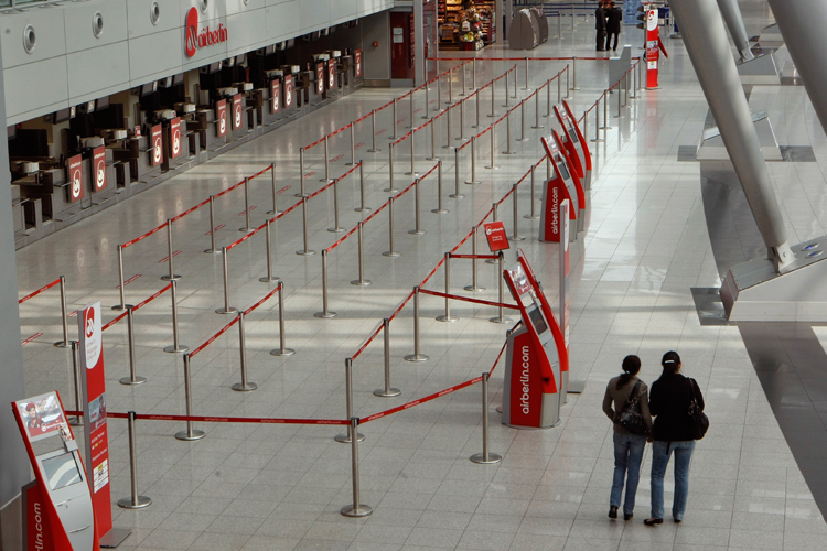 Two women look at the arrival hall of Duesseldorf's airport on Monday.
