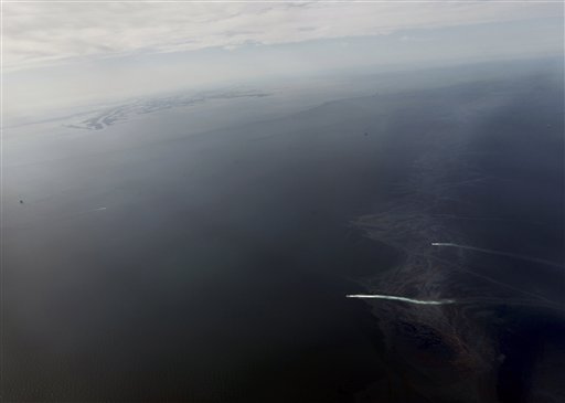 Oil, bottom right, is seen approaching the Louisiana Coast, top left,  in this aerial photo taken 8 miles from shore, Wednesday, April 28, 2010.  The massive oil spill in the Gulf of Mexico is even worse than believed and as the government grows concerned that the rig's operator is ill-equipped to contain it, officials are offering a military response to try to avert a massive environmental disaster along the ecologically fragile U.S. coastline.(AP Photo/Gerald Herbert) (AP)