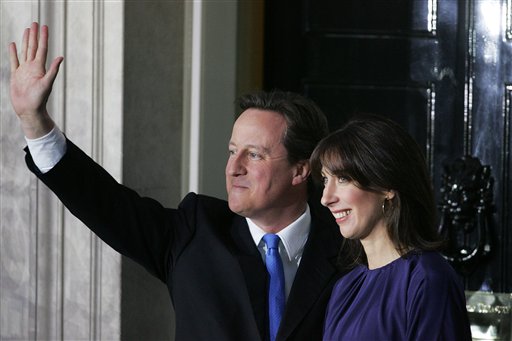 Britain's new Prime Minister David Cameron and his wife Samantha wave to the media outside 10 Downing Street in London,Tuesday, May, 11  2010. (AP Photo/Tim Hales) (AP)