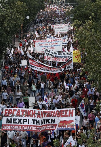 Pro communist protesters march during an anti government rally in Athens on Thursday, May 6, 2010. Greek lawmakers approved a crucial austerity bill Thursday needed to tap 110 billion ($140 billion) in bailout loans from other eurozone countries and the International Monetary Fund, as massive crowds gathered outside parliament to protest the measures. The bill passed with 172 votes in favor and 121 against. Greeks have been outraged by the government's proposed fiscal measures, and demonstrations turned violent on Wednesday during a nationwide general strike, leaving three people dead after becoming trapped in a burning bank torched by demonstrators. (AP Photo/Dimitri Messinis) (AP)