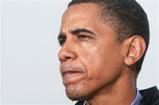 Standing in the rain, President Barack Obama makes a statement to reporters at the Coast Guard Venice Station in Venice, La., as he visits the Gulf Coast region affected by the BP (British Petroleum) oil well spill, Sunday, May 2, 2010. (AP Photo/Charles Dharapak) (AP)