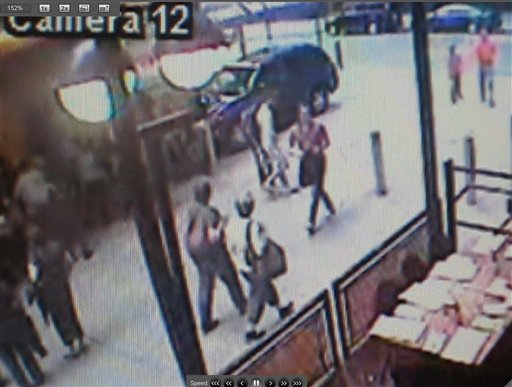 ** CORRECTS MONTH TO MAY **A frame made from a surveillance video released by the New York Police Monday May 3, 2010, shows a man, center,carying a bag and walking away after removing a shirt in an alleyway in New York.  Police investigating a failed car bomb left in Times Square say the videotape tape shows a possible suspect.  (AP Photo/NYPD) (AP)