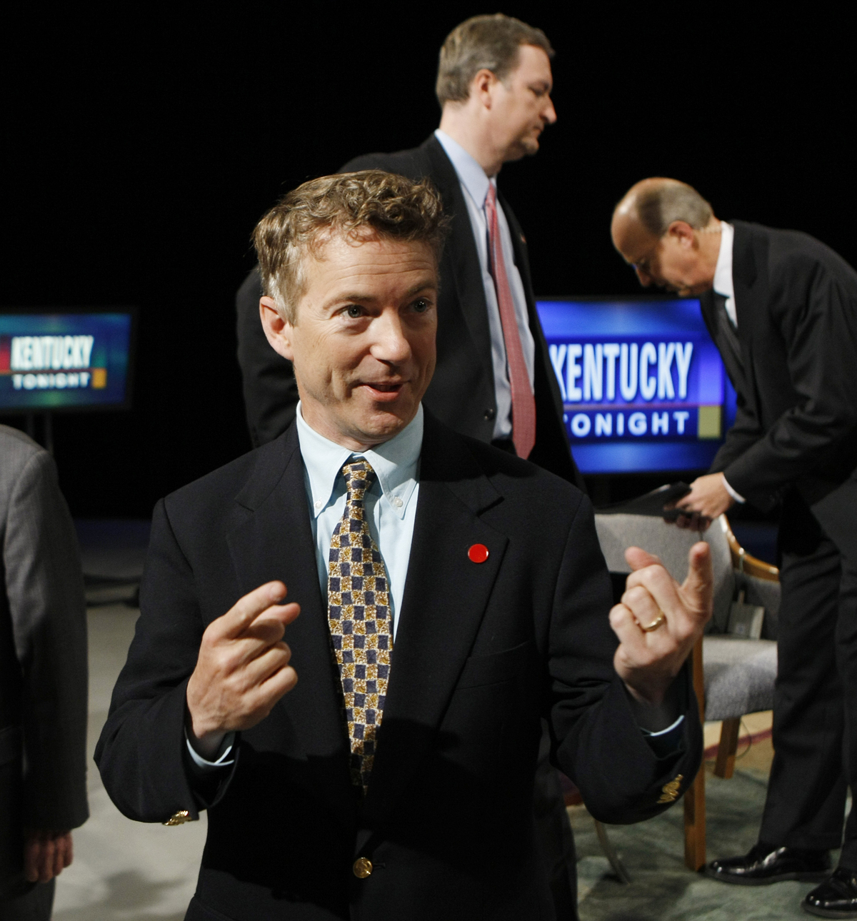 Republican U.S. Senate candidate Rand Paul talks with a person in the foreground as opponent C.M. "Trey" Grayson, top, and host Bill Goodman await the beginning of a televised candidate forum in Lexington, Ky., Monday, May 10, 2010.  (AP Photo/Ed Reinke) (Ed Reinke)