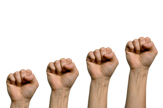 A closed fist of a woman in a white background (Helder Almeida)