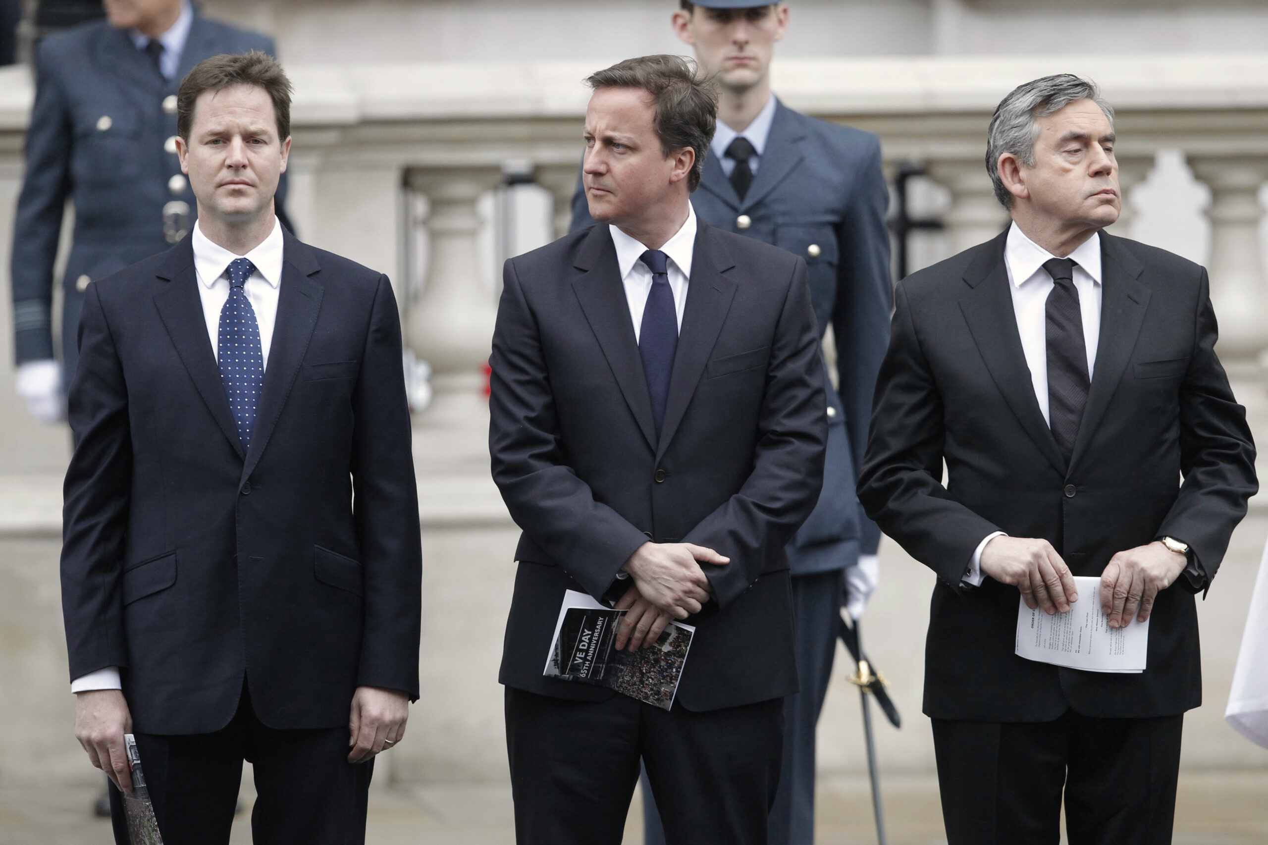 Britain's Prime Minister Gordon Brown (R) stands with Conservative Party leader David Cameron and Liberal Democrat leader Nick Clegg during a Victory in Europe (VE) day ceremony in central London May 8, 2010. Clegg sought backing from senior party members on Saturday for a possible deal with the Conservatives after an election in which no party won an outright majority. The centre-right Conservatives under Cameron won the most parliamentary seats in Thursday's election but need the support of other parties to form a stable government that can tackle a record budget deficit.   REUTERS/Luke Macgregor       (BRITAIN - Tags: POLITICS ELECTIONS IMAGES OF THE DAY ANNIVERSARY) (Reuters)