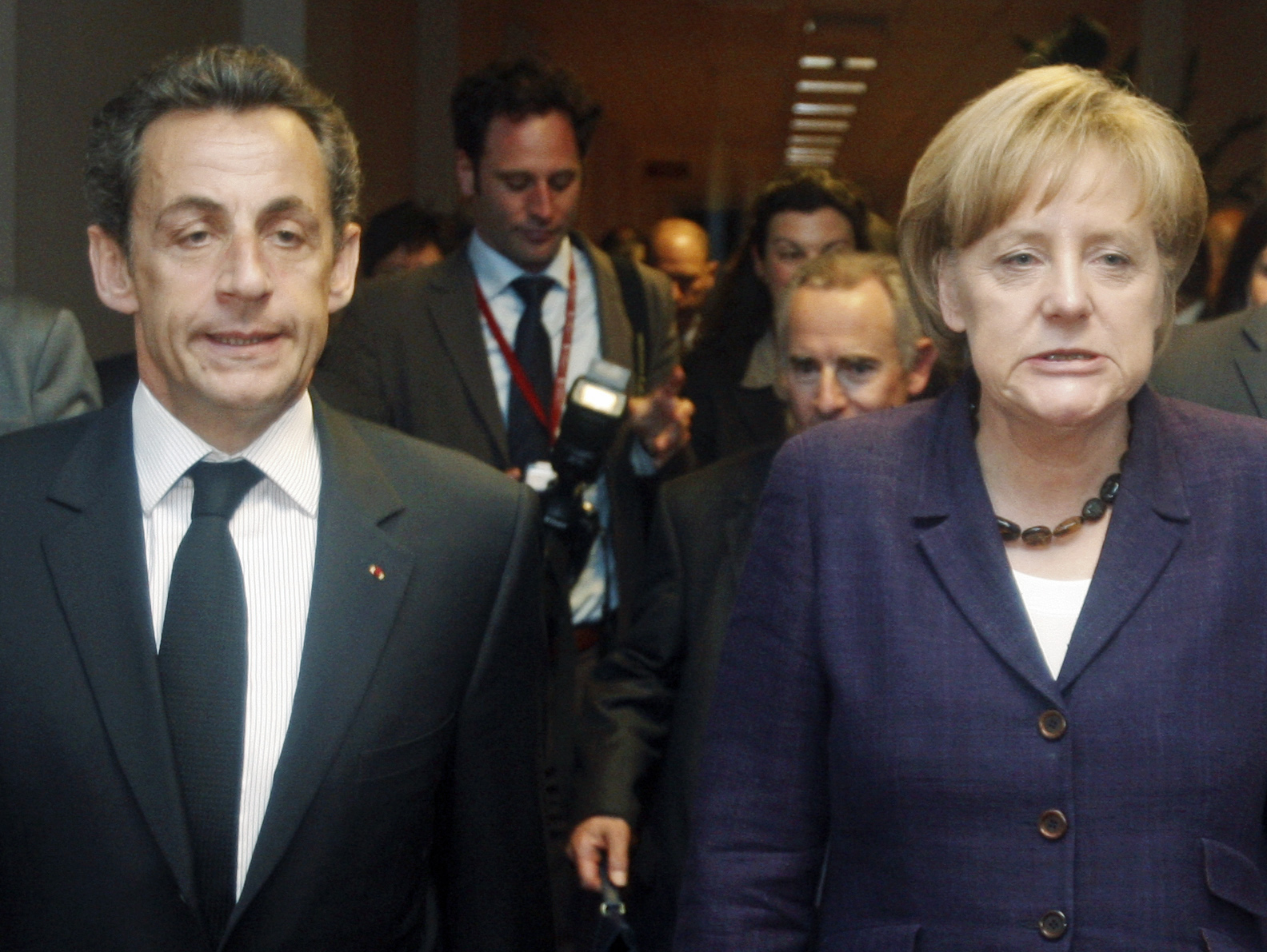France's President Nicolas Sarkozy (L) and Germany's Chancellor Angela Merkel (R) walk together during a Euro Zone leaders summit in Brussels, May 7, 2010. Euro zone leaders agreed on Friday that they would have special measures ready before financial markets open on Monday to prevent financial turmoil in Greece spreading to other countries such as Spain and Portugal. Photo taken May 7, 2010.  REUTERS/Michel Euler/Pool  (BELGIUM - Tags: POLITICS BUSINESS IMAGES OF THE DAY) (Reuters)