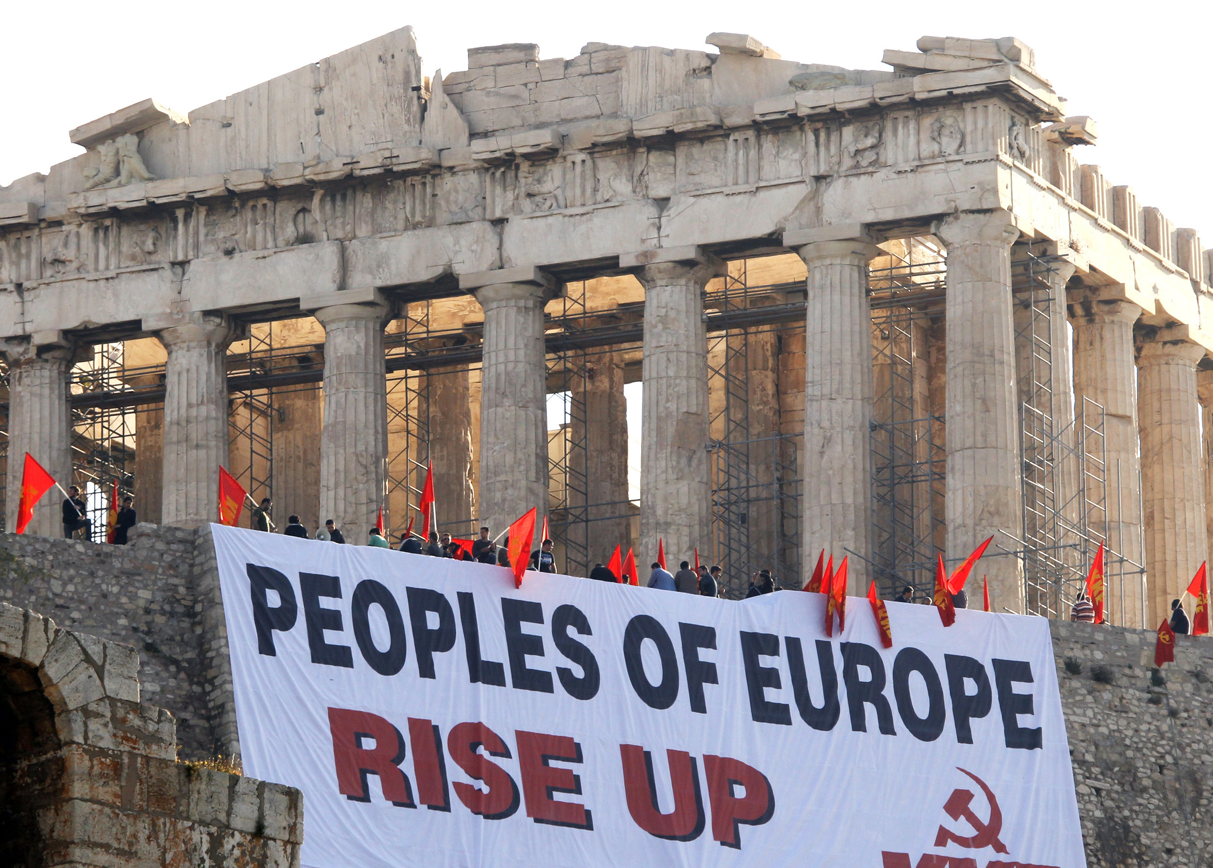A giant banner protesting Greece's austerity measures hangs near the Parthenon on Acropolis hill in Athens early May 4, 2010. A group of demonstrators from Greece's communist party, KKE, staged the protest atop the Acropolis as Athens braced for a 48-hour nationwide strike by civil servants which would also include the shutdown of travel services.    REUTERS/Pascal Rossignol  (GREECE - Tags: EMPLOYMENT BUSINESS POLITICS CIVIL UNREST) (Reuters)