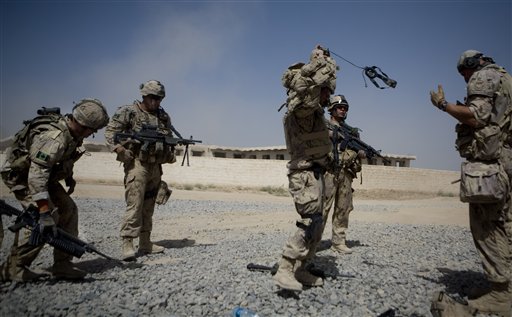 Canadian soldiers with 1st RCR Battle Group, The Royal Canadian Regiment, get ready to reinforce troops after one of their comrades got injured by an IED blast during a patrol outside Salavat, in the Panjwayi district, southwest of Kandahar, Afghanistan, Monday, June 7, 2010. IEDs have been the single biggest cause of death among Canadian troops in Afghanistan. Seven out of nine Canadian deaths this year were the result of IED blasts. (AP Photo/Anja Niedringhaus) (AP)