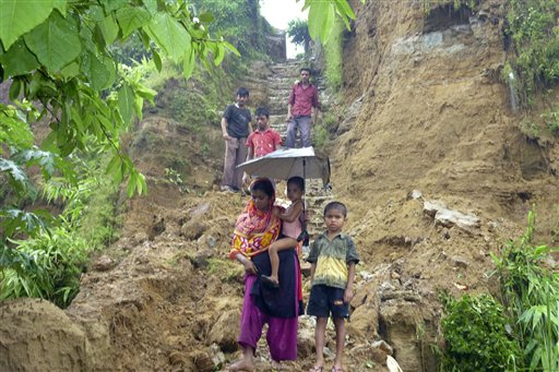 Bangladeshi villagers walk down from their hilltop home after landslides struck in the southern coastal area of Cox's Bazar, 185 miles (296 kilometers) south of Dhaka, Bangladesh, Tuesday, June 15, 2010. Powerful landslides triggered by heavy rains killed at least 38 people and left seven army soldiers missing in southeastern Bangladesh. (AP Photo/Tofayel Ahmed) (AP)