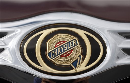 FILE - In this June 18, 2009 file photo, the Chrysler logo shines on the grille of a 2009 Chrysler Town & Country minivan at a Chrysler-Jeep dealership in the Colorado city of Centennial. Federal regulators said Monday, June 7, 2010, Chrysler is recalling nearly 600,000 Jeep Wranglers and Chrysler and Dodge minivans for brake or wiring problems. (AP Photo/David Zalubowski, file) (AP)