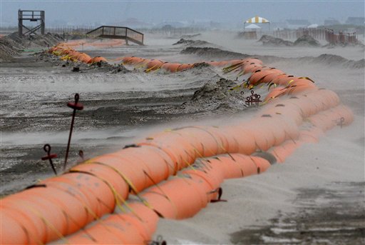Sand blows across a tiger dam on a beach as the outer edges of Tropical Storm Alex approach the Louisiana coast in Grand Isle, La., Tuesday, June 29, 2010. The dam is expected to protect the island's beaches from oil that washes ashore from April's Deepwater Horizon oil rig explosion and spill in the Gulf of Mexico. (AP Photo/Patrick Semansky) (AP)