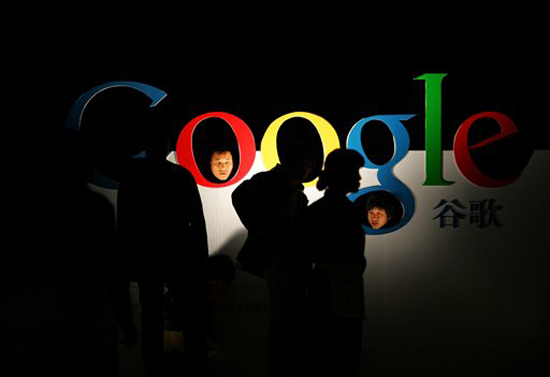 FILE - In this April 12, 2006 file photo, Chinese poke their heads through a Google logo shortly after Google debuts its Chinese Language brand name in the Beijing Hotel in Beijing. Google Inc. said Tuesday, June 29, 2010, it will stop automatically rerouting users of its China search site to its Hong Kong site after Beijing said the company would lose its mainland Internet license if the tactic continued. (AP Photo/Elizabeth Dalziel, File) (Elizabeth Dalziel)