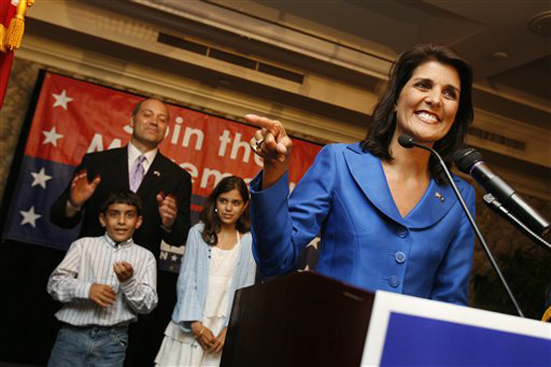 Rep. Nikki Haley, R-Lexington,who garnered the most votes in the GOP gubernatorial primary  gives a victory speech to supporters at the Capital City Club in Columbia, S.C., on Tuesday, June 8, 2010.  Haley will face Rep. Gresham Barrett in a runoff election in two weeks for the GOP nomination.   Her husband Michael, son Nalin and daughter Rana stand behind her. (AP Photo/Rich Glickstein/The State) (Rich Glickstein)