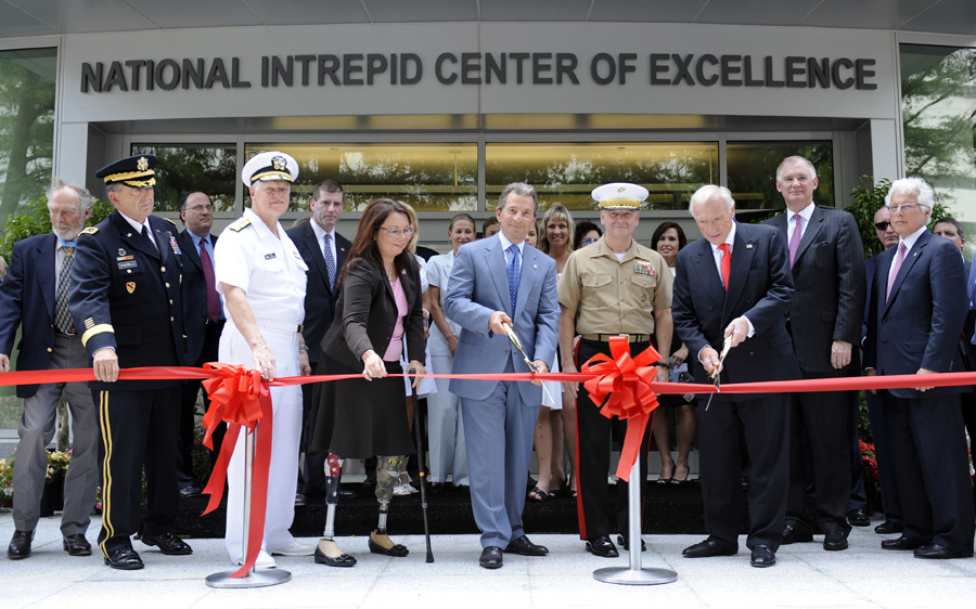 Richard Santulli, chairman of the Intrepid Fallen Hero Fund, holding scissors at center, and Arnold Fisher, honorary chairman of the Intrepid Fallen Hero Fund, with scissors third from right, cut the ribbon during the dedication of the National Intrepid Center of Excellence at the National Naval Medical Center in Bethesda, Md., Thursday, June 24, 2010. Also participating in the event is Assistant Veterans Affairs Secretary Tammy Duckworth, with cane.  (AP Photo/Susan Walsh) (Susan Walsh)
