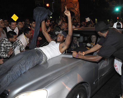 Los Angeles Laker fans celebrate while police try to control a crowd on the street outside the Staples Center in Los Angeles after Game 7 of the NBA finals on Thursday, June 17, 2010.  (AP Photo/Dan Steinberg) (AP)
