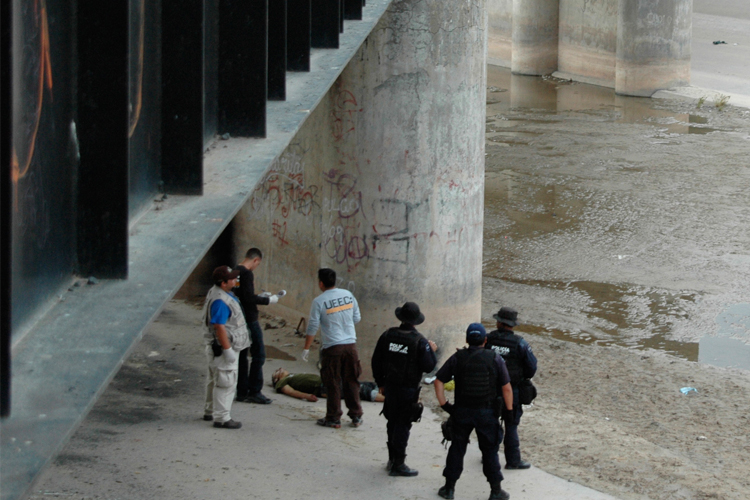 Forensic experts examine the body  Sergio Adrian Hernandez Huereca on Monday, June 7.