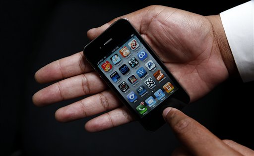 An Associated Press reporter holds the new Apple iPhone during a product test review in San Francisco, Thursday, June 24, 2010. (AP Photo/Jeff Chiu) (AP)