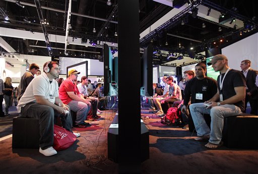 FILE - In this June 2, 2009 file photo, show attendees play video games at the Activision booth at the E3 Expo in Los Angeles. (AP Photo/Jae C. Hong, file) (AP)