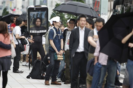 Customers line up to buy Apple's newest iPhone outside an Apple Inc's store at the Ginza district in Tokyo, Japan Thursday, June 24, 2010. Hundreds more lined up across the city at Apple stores and other Softbank outlets. (AP Photo/Shizuo Kambayashi) (AP)