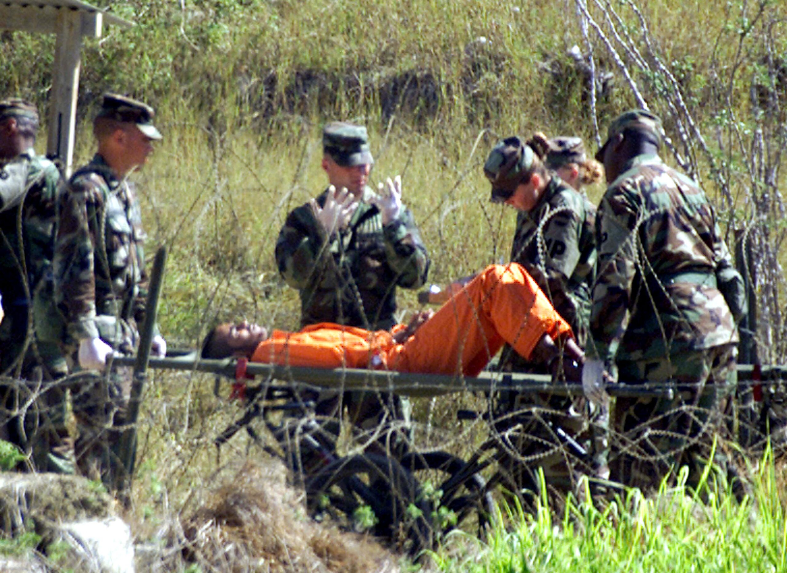Military Police at camp X-Ray on the Naval Base at Guantanamo Bay,
Cuba, bring a detainee, who arrived at the camp injured, from an
interigation room after questioning February 2, 2002. The U.S. military
finished construction of a temporary prison camp on the U.S. Navy base
in Guantanamo Bay, Cuba, on Saturday, and can now more than double its
population of Taliban and al Qaeda prisoners, camp officials said.
REUTERS/Marc Serota

JP (Reuters)