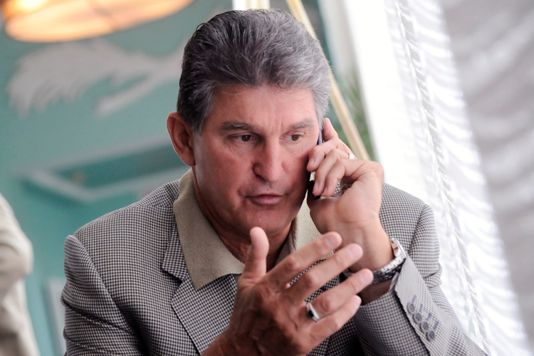 West Virginia Gov. Joe Manchin speaks on the phone about the death of Sen. Robert C. Byrd on Monday.