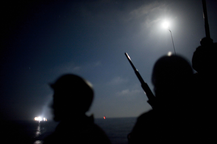 The view from aboard an Israeli naval vessel, as Israeli navy soldiers intercept several boats headed toward the Gaza Strip, while in international waters, early Monday.