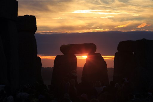 The sun is rising behind the Stonehenge monument in England, during the summer solstice shortly after 04:52 am, early Monday, June 21, 2010. Druids, pagans and partygoers crammed into the mystic stone circle to cheer, bang drums and shake tambourines in an effort to greet the sun on the longest day of the year in the northern hemisphere, the summer solstice. Stonehenge, on the Salisbury Plain about 140 kilometers (90 miles) southwest of London, was built over three phases between 3,000 B.C. and 1,600 B.C. It is one of Britain's most popular tourist attractions; more than 750,000 people visit every year. (AP Photo/Lefteris Pitarakis) (AP)