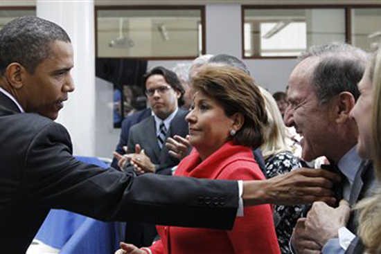 President Barack Obama adjusts the collar of Mort Zuckerman, Chief Executive Officer of U.S. News and World Report, right, as Janet Murguia, President and CEO, National Council of La Raza, looks on, after Obama spoke about immigration reform, Thursday, July 1, 2010,  at American University in Washington. (AP Photo/Charles Dharapak) (Charles Dharapak)