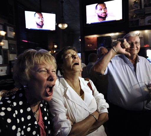 Chicago Bulls fans Marianne Gilligan, left, Ann Deignan, middle, and Ed Gilligan react while watching LeBron James announce on television that he will play for the Miami Heat, at Harry Caray's restaurant in Chicago, Thursday, July 8, 2010. (AP Photo/Paul Beaty) (AP)