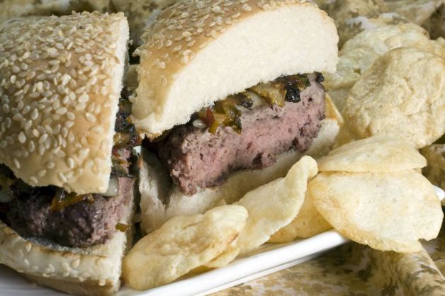 Adam Perry Lang's griddled and grilled Monterey Jack cheeseburger with spicy chipotle caramelized onions and cilantro.