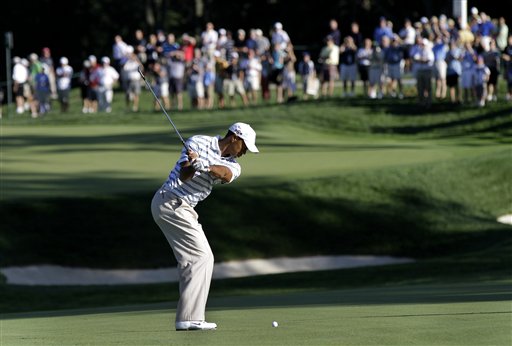 Tiger Woods hits to the seventh green while playing in a Pro-Am for the AT&T National golf tournament at Aronimink Golf Club in Newtown Square, Pa., Wednesday, June 30, 2010. (AP Photo/Rob Carr) (AP)