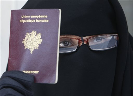France's Najat shows her European passport, as dressed in a niqab, she addresses reporters during a press conference in Montreuil, east of Paris, Tuesday May 18, 2010. The French government will examine Wednesday,  a proposed bill forbidding burqa-style Islamic veils that cover the face, on the grounds that they do not respect French values or women's dignity.(AP Photo/Remy de la Mauviniere) (AP)
