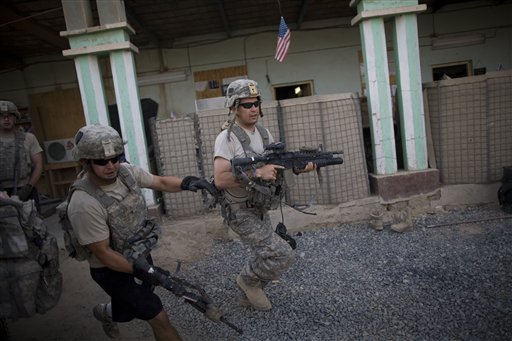 US soldiers from 1-320th Alpha Battery, 2nd Brigade of the 101st Airborne Division, run to firing positions after coming under attack by Taliban insurgents at COP Nolen, in the volatile Arghandab Valley, Kandahar, Afghanistan, Tuesday, July 27, 2010. (AP Photo/Rodrigo Abd) (AP)