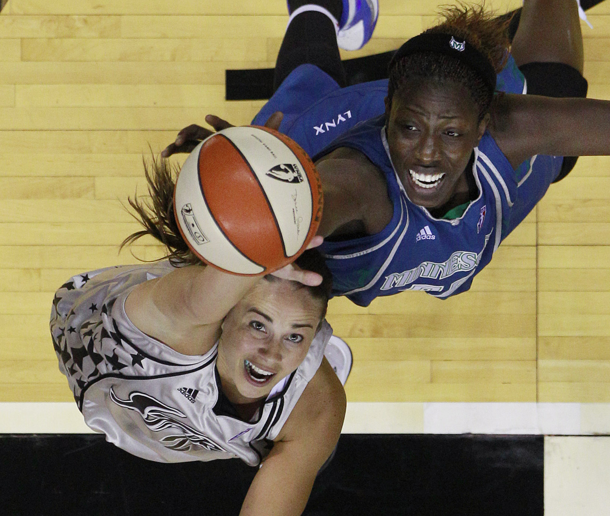 San Antonio Silver Spur's Becky Hammon, left, and Minnesota Lynx's Hamchetou Maiga-Ba, right, compete for a rebound during the fourth quarter of a WNBA basketball game, Saturday, June 26, 2010 in San Antonio. San Antonio won 80-66. (AP Photo/Eric Gay) (Eric Gay)